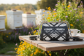 Hot Metal Flat Frame Bag Close Up on Cafe Table at Apiary Mockup