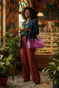 Pink Leaf Large Duffle Bag shoulder strap worn crossbody colorful train station cafe mockup